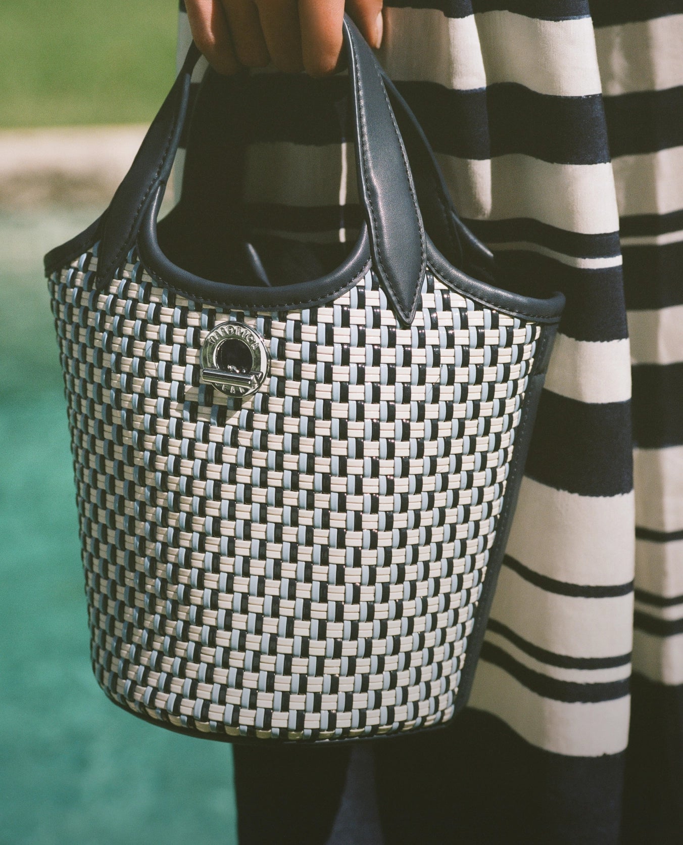 Veronica Beard Woven bucket bag with black and white checkered pattern, black leather trim, and a silver clasp.
