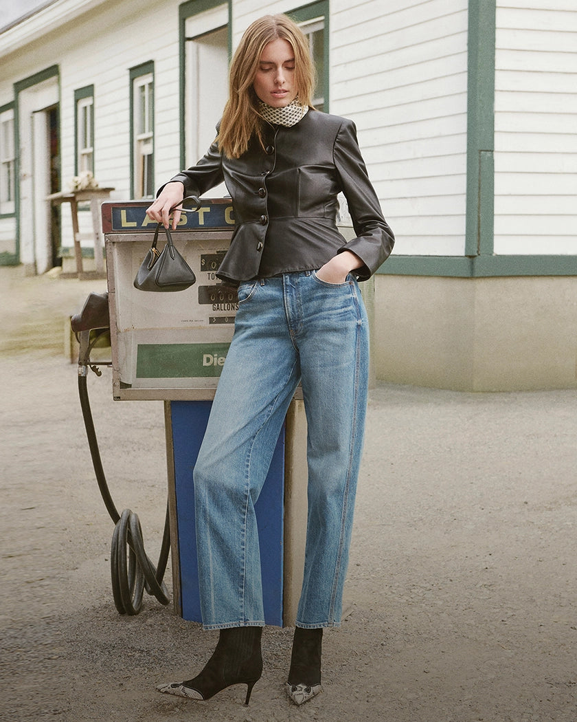 Veronica Beard Black leather peplum jacket, blue wide-leg jeans.