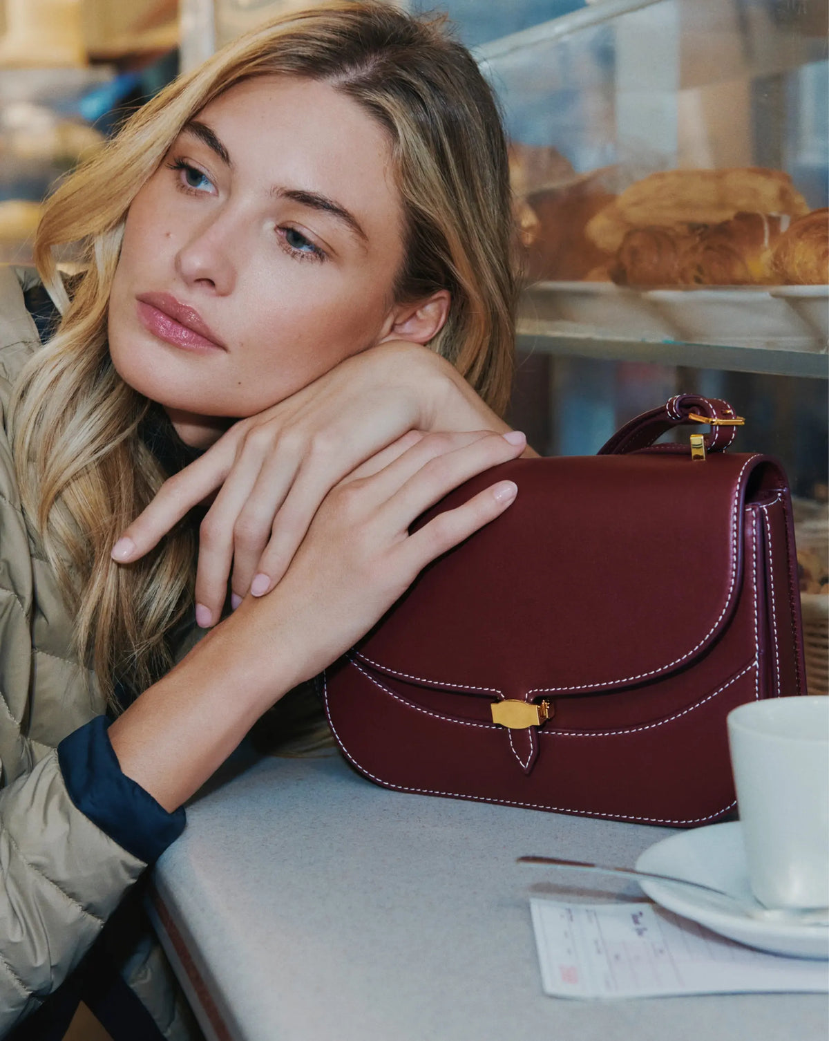 Veronica Beard Burgundy leather saddle bag with gold clasp.