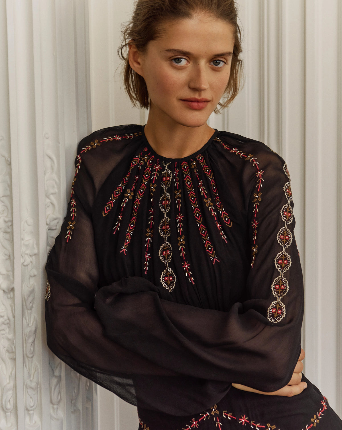 Veronica Beard Black embroidered dress with red and gold details.