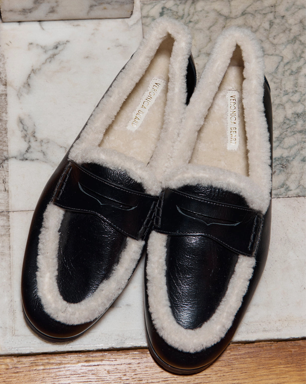 Veronica Beard Black patent leather shearling-lined slip-on loafer.