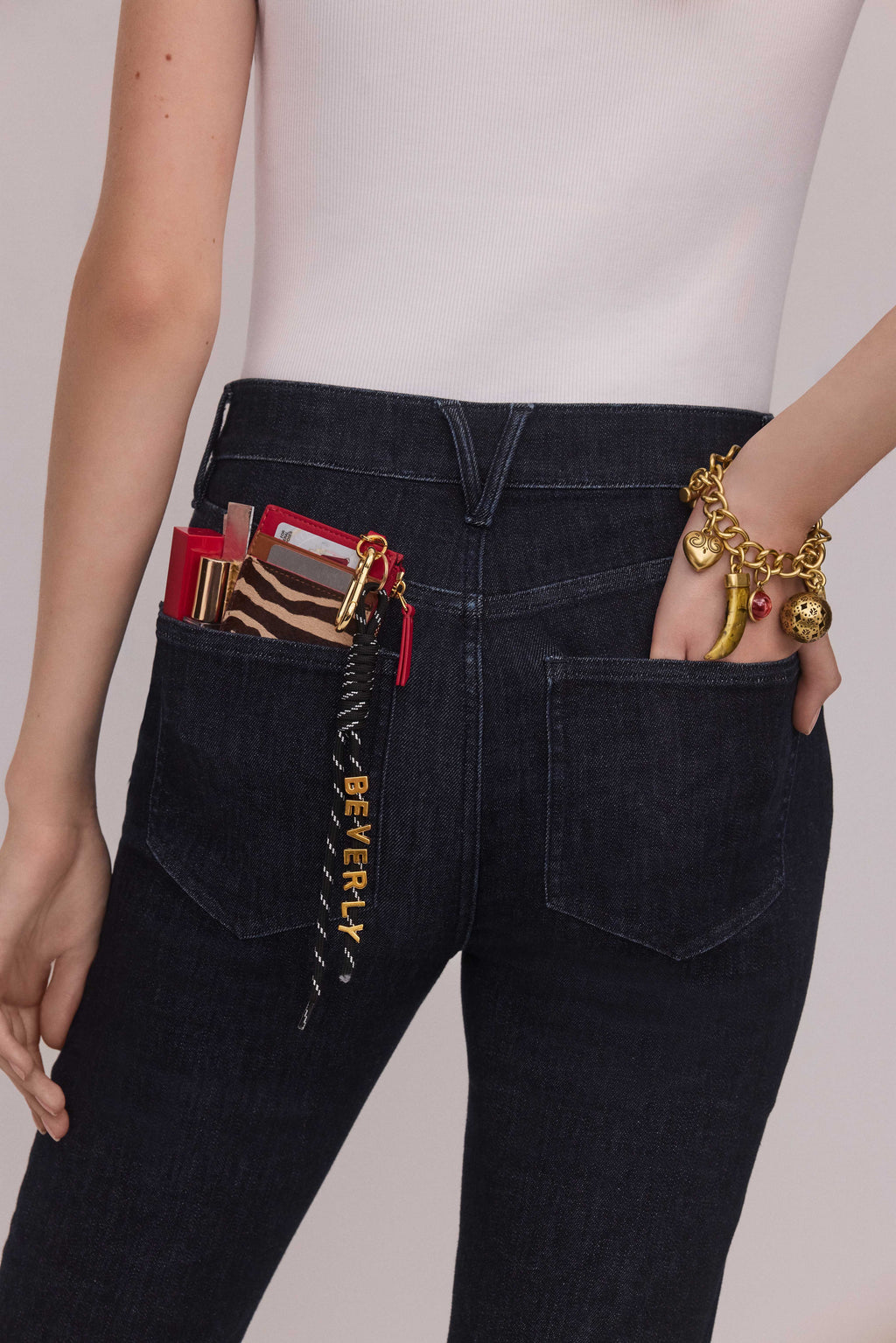 Veronica Beard Red leather card case with gold zipper and carabiner.
