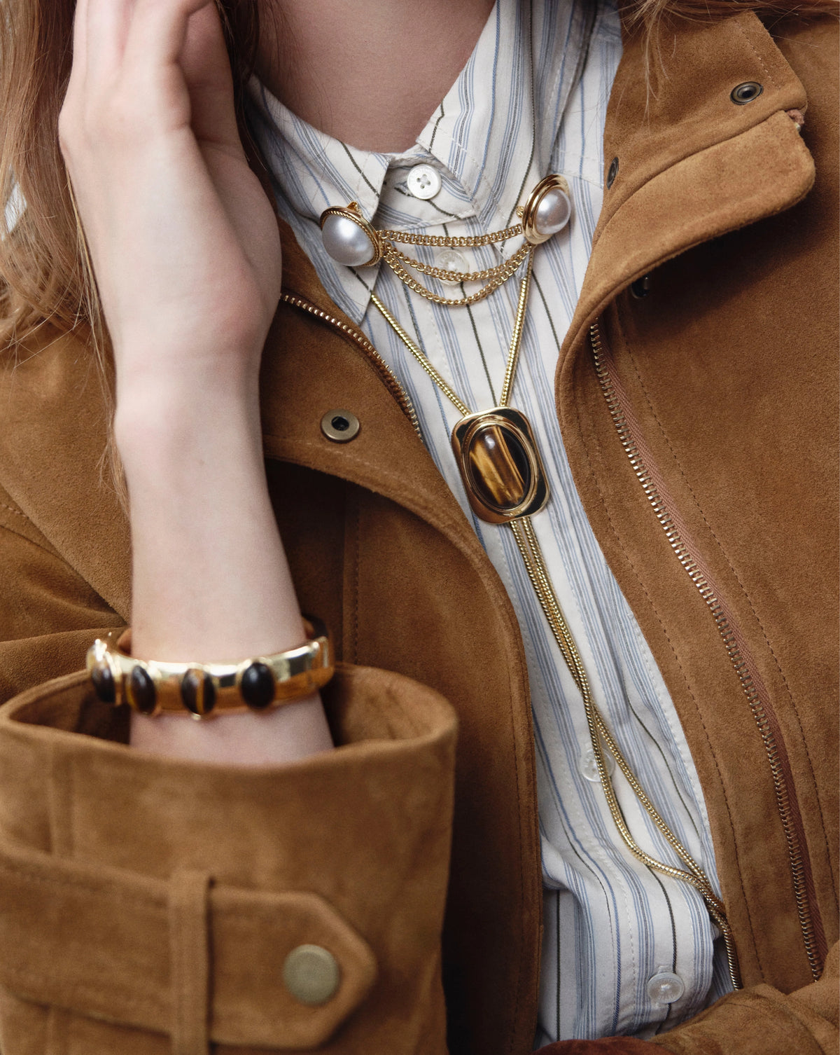 Veronica Beard Gold triple chain brooch with two white pearls.