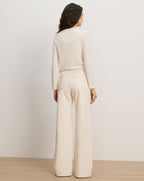 Veronica Beard Cream knit cardigan with "STRESS DOESN'T GO WITH MY OUTFIT" embroidered in black.