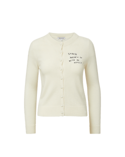 Veronica Beard Cream knit cardigan with "Stress doesn't go with my outfit" embroidered on the chest.
