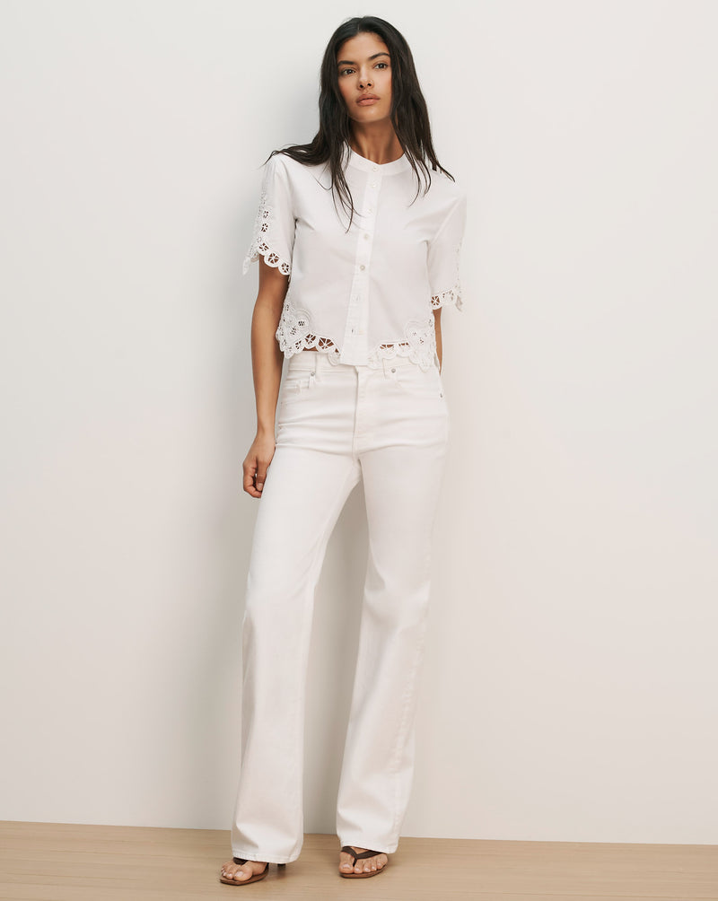 Veronica Beard White eyelet short-sleeve button-up shirt and white wide-leg jeans.