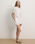 Veronica Beard White cotton eyelet short-sleeve shirt and matching shorts with scalloped hems.