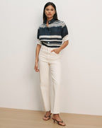 Veronica Beard Navy and white striped short-sleeve button-up shirt with cream high-waisted straight-leg jeans.