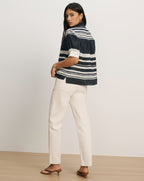 Veronica Beard Navy and white striped short-sleeve button-up shirt with white cuffs and off-white straight-leg pants.