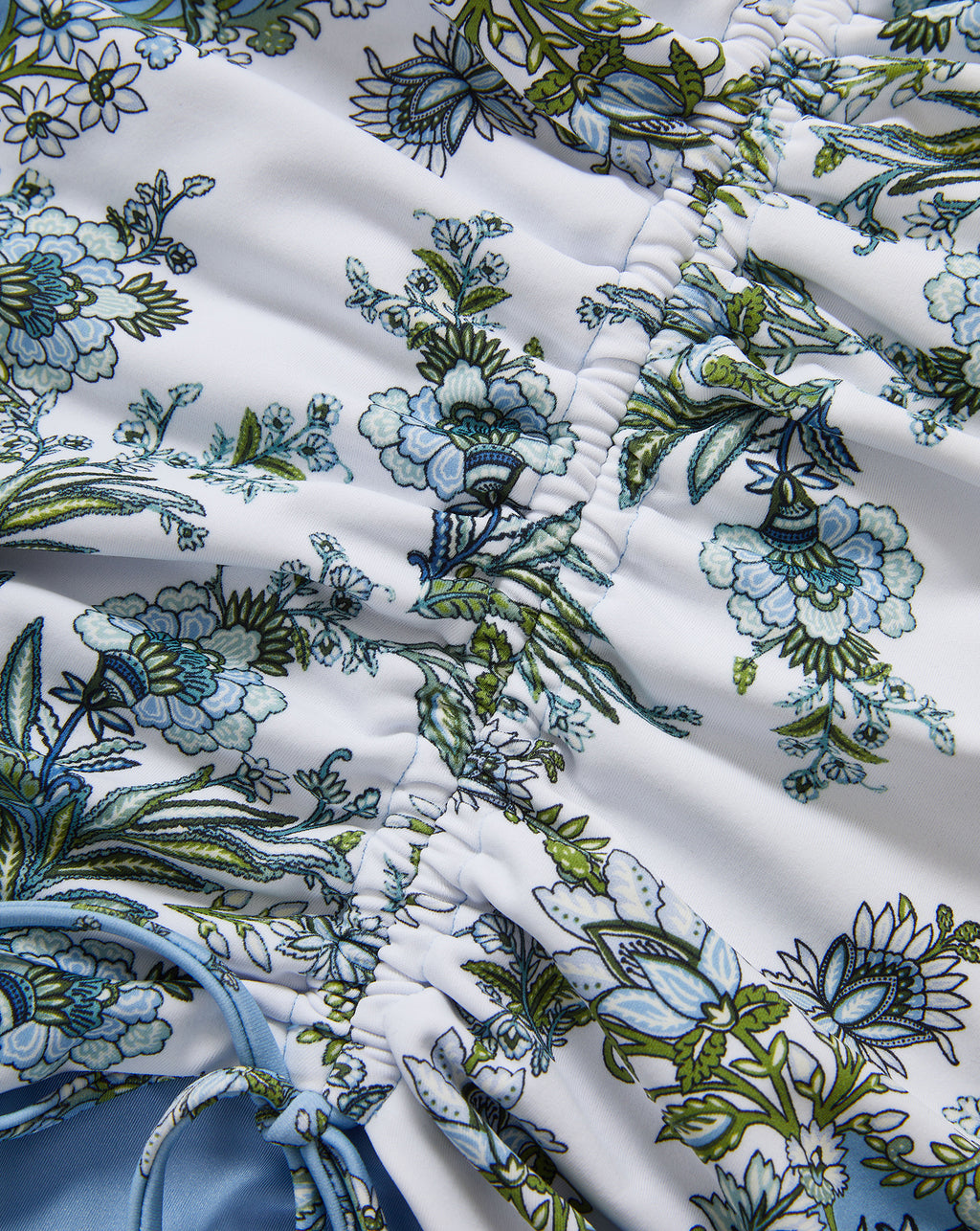 Veronica Beard White ruched swimsuit with blue and green floral print.