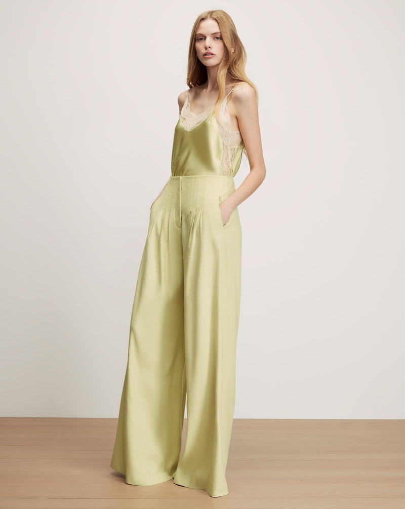 Veronica Beard Lime green satin camisole with lace trim and matching wide-leg pleated pants.