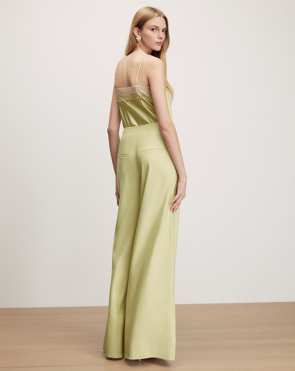Veronica Beard Light green high-waisted wide-leg pleated trousers.