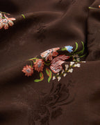 Veronica Beard Black floral print camisole with spaghetti straps and white wide-leg jeans.