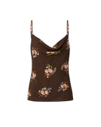 Veronica Beard Black floral print camisole with spaghetti straps and white wide-leg jeans.
