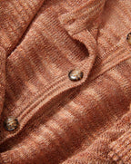 Veronica Beard Coral textured knit cardigan with short sleeves and light wash denim shorts.