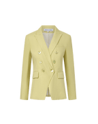 Veronica Beard Light green double-breasted blazer with peak lapels, paired with a white button-down shirt and off-white trousers.