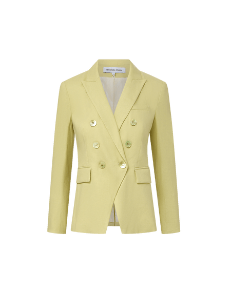 Veronica Beard Light green double-breasted blazer with peak lapels, paired with a white button-down shirt and off-white trousers.