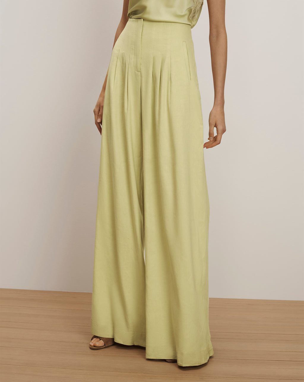 Veronica Beard Light green high-waisted wide-leg pleated trousers.