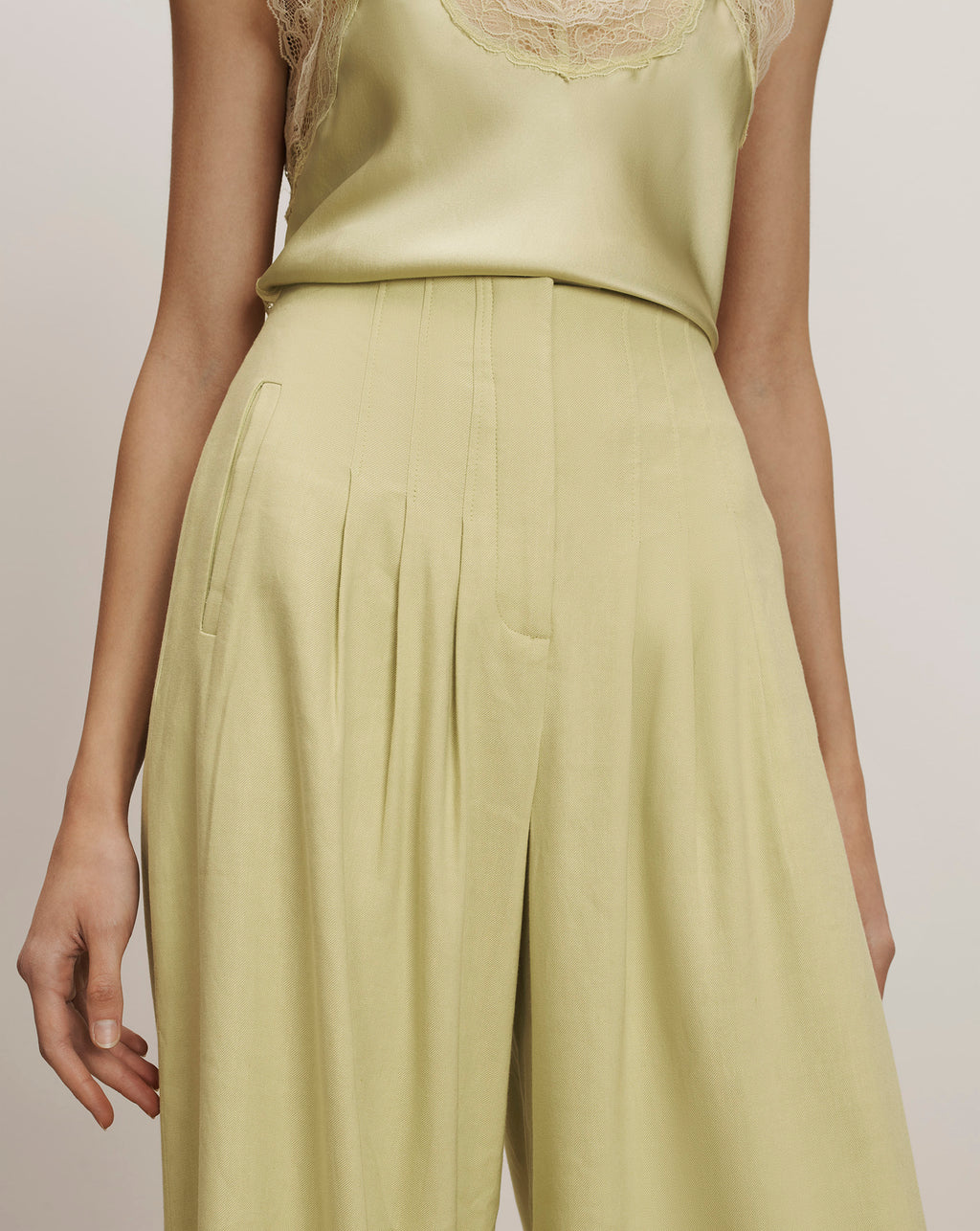 Veronica Beard Light green wide-leg trousers with pleats and a matching silk camisole with lace trim.