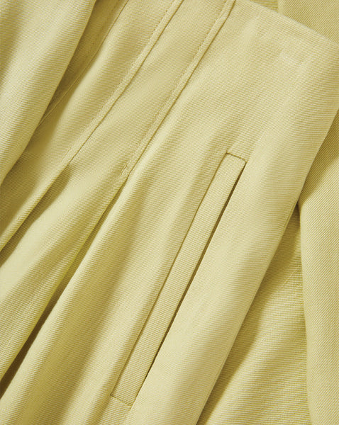 The image depicts a close-up view of a beige or cream-colored fabric, with intricate folds and pleats creating a textured and visually interesting pattern.