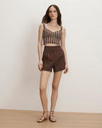 Veronica Beard Brown and white striped bustier crop top with brown pleated shorts.