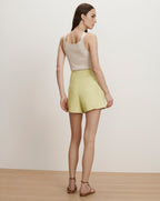 Veronica Beard Ribbed cream knit tank top and light yellow high-waisted shorts.
