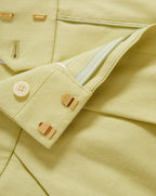 Veronica Beard Ribbed beige tank top and lime green pleated shorts.