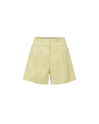 Veronica Beard Ribbed beige tank top and lime green pleated shorts.