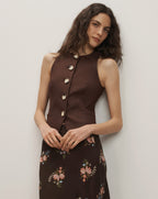 Veronica Beard Brown linen blend button-up vest with a round neck and a dark brown floral midi skirt.