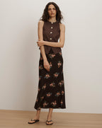 Veronica Beard Brown sleeveless button-front vest and black floral midi skirt.