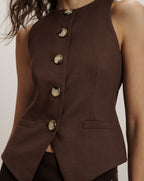 Veronica Beard Brown sleeveless vest with a round neck, four large buttons, and two small front pockets.