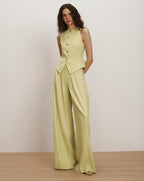 Veronica Beard Light green vest with wide-leg pleated trousers and a lace camisole.
