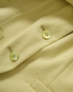 Veronica Beard Light green sleeveless vest with gold buttons and matching wide-leg pleated trousers.
