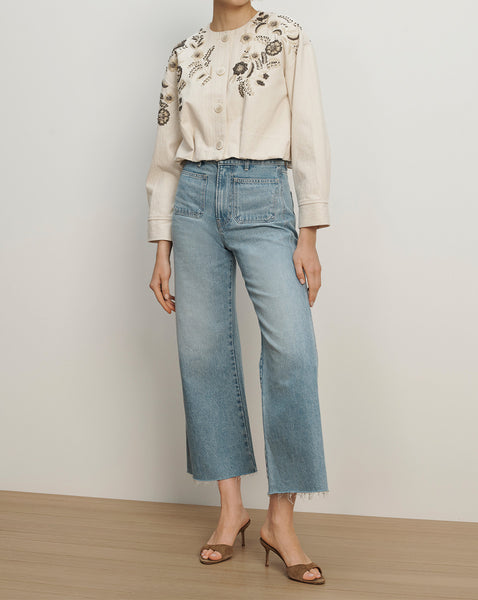 Veronica Beard Beige embroidered jacket and light wash wide-leg jeans.