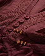 Veronica Beard Brown dress with lace trim, buttons, and beaded tassels.