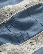 Veronica Beard Blue top with white lace trim and embroidered details.