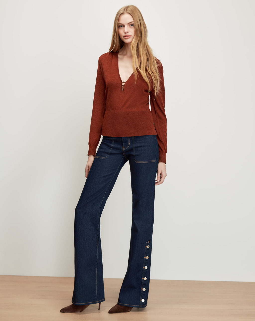Veronica Beard Brown knit sweater, dark wash flared jeans with buttons.