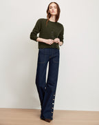 Veronica Beard Dark green cardigan and dark wash jeans with side buttons.