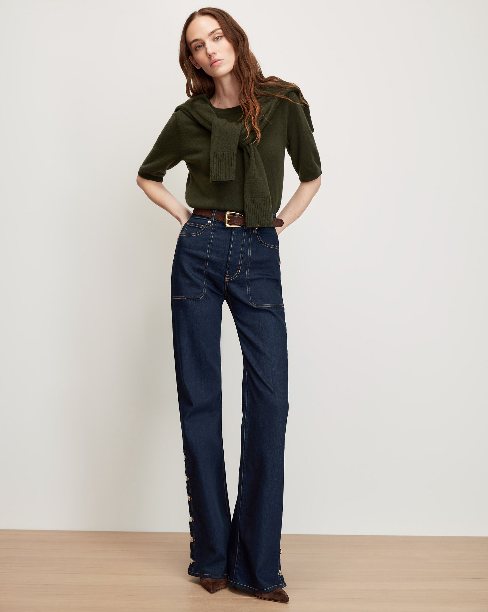 Veronica Beard Dark wash wide-leg jeans with buttoned cuffs.