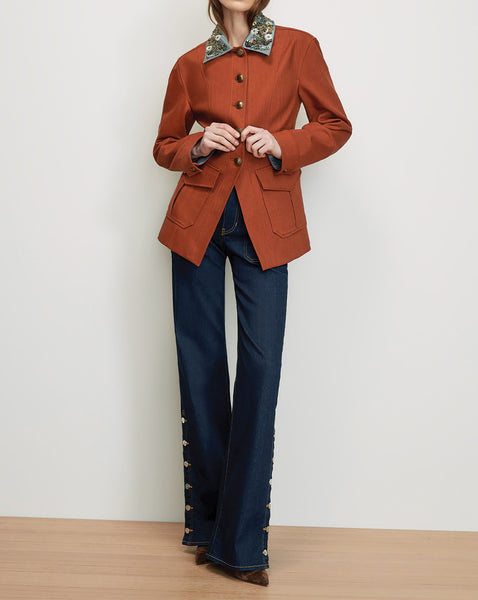 Veronica Beard Rust blazer with embellished collar and dark wash jeans.