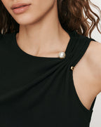 Veronica Beard Black ribbed knit top with pearl button detail.