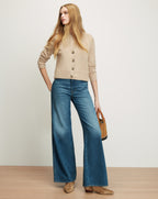 Veronica Beard Beige knit cardigan and wide-leg blue jeans.