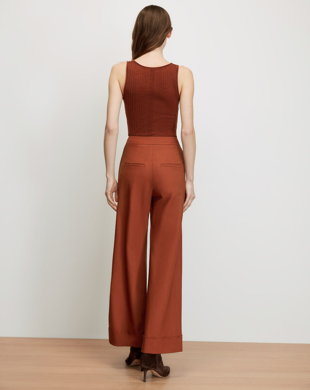 Veronica Beard Brown ribbed tank top and rust wide-leg pants.