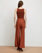 Veronica Beard Brown ribbed tank top and rust wide-leg pants.