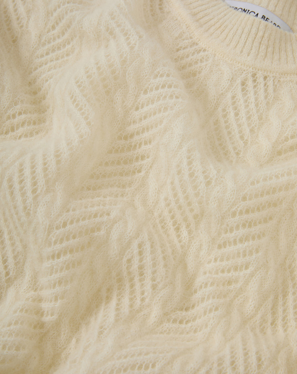 Veronica Beard Cream open-knit sweater with chevron pattern.