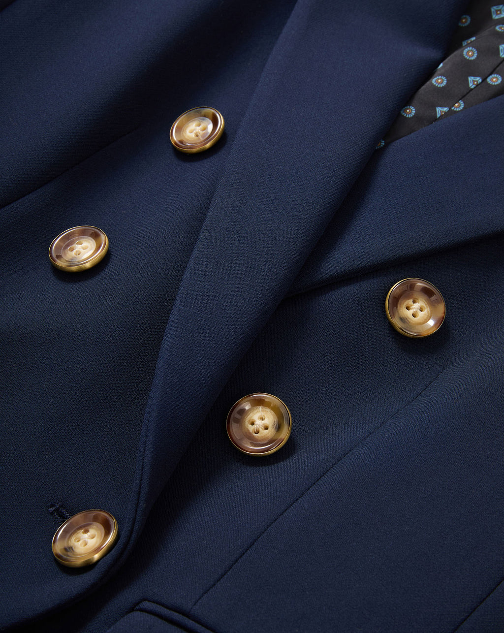 Veronica Beard Navy blue double-breasted blazer with brown buttons.