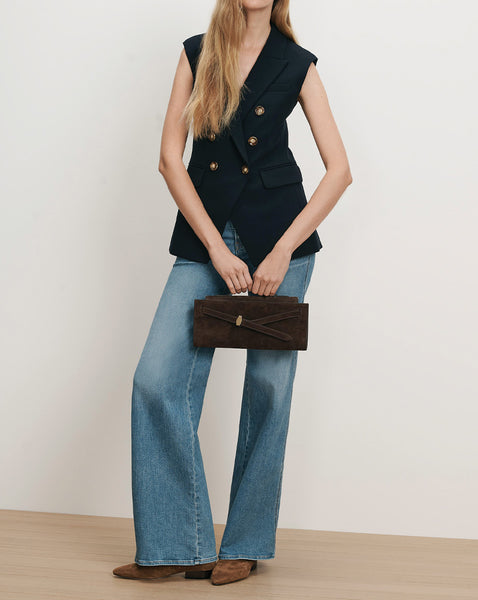 Veronica Beard Navy double-breasted vest, light wash flared jeans.