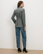 Veronica Beard Gray blazer with cinched waist and blue jeans.
