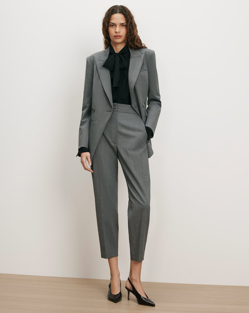 Veronica Beard Gray suit with black blouse and bow.
