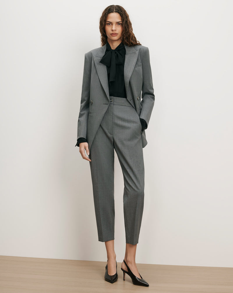 Veronica Beard Gray wool suit with black blouse and heels.